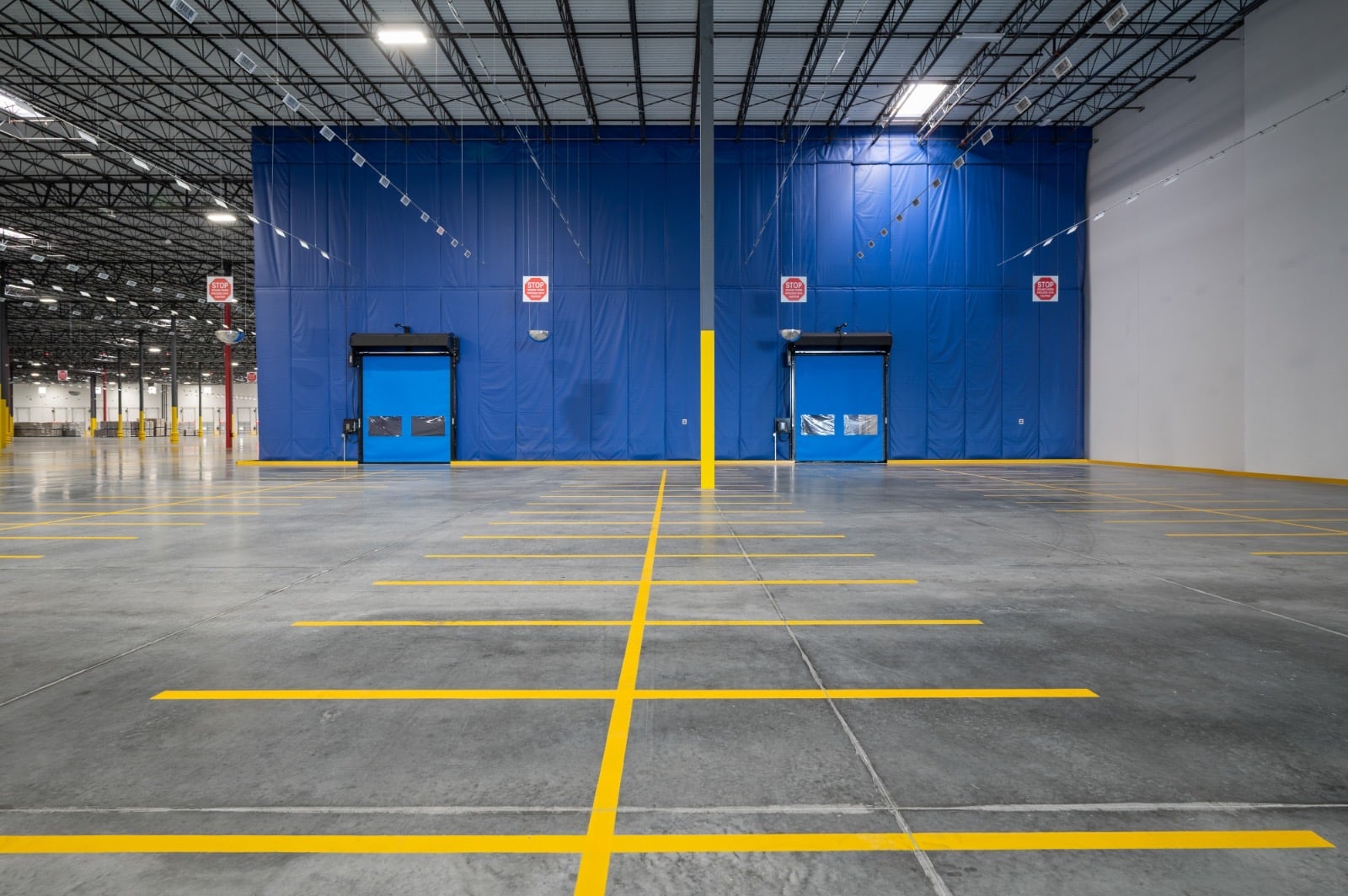 Warehouse enclosure with yellow floor striping