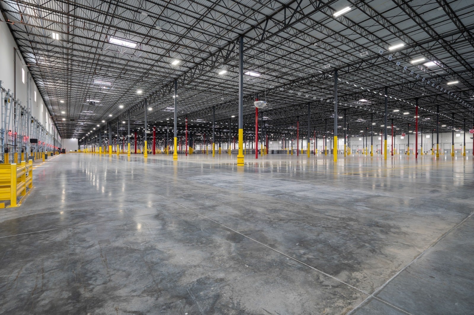 Expansive distribution facility floor with steel columns and sealed concrete